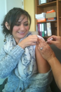 Case Manager Ali Neira getting her Free Flu Shot from a San Mateo County health nurse